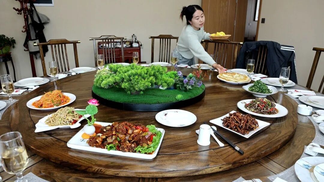 何沟门安置小区美食馆内,服务员有序上菜。